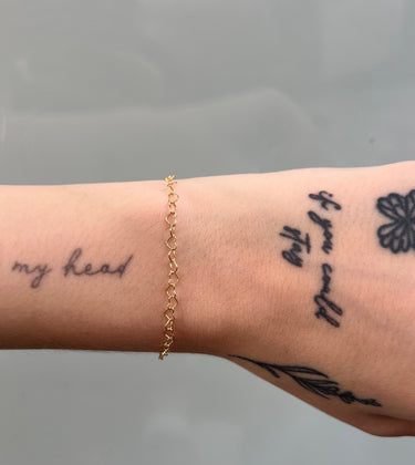 Heart link chain with gold filled links on wrist