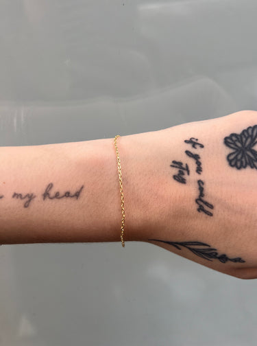 Gold chain with oval shaped links on wristt