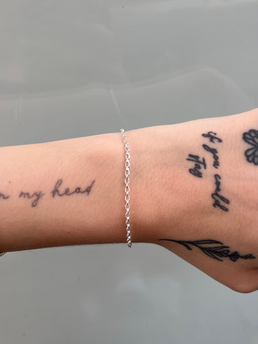 silver chain with rounded rolo links on wrist