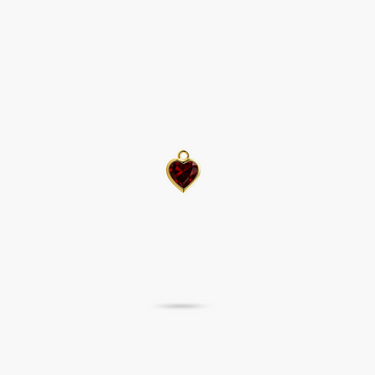 A heart shaped garnet stone encased with yellow gold
