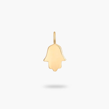 A 14k solid gold charm of the hamsa hand.