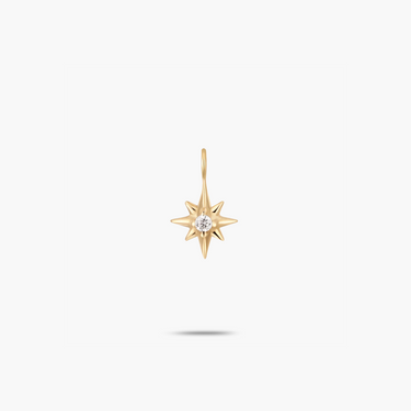 A 14k yellow gold north star charm with a natural diamond.