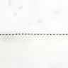 Gold chain with black diamonds on a white background