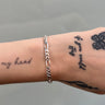 chunky figaro style silver chain on wrist