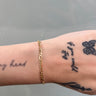 14k gold figaro style chain on wrist