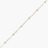 Silver chain with gold beads on a white background