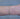Silver chain with gold beads on a person's wrist on grey background