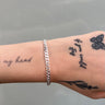 Medium thick silver curb chain on wrist