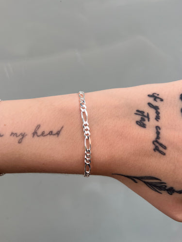 Chunky figaro style silver chain on wrist