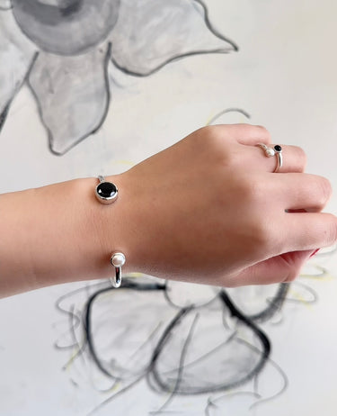 model shot of Amare Wear Black Spinel and Freshwater Pearl Silver Handcuff Bracelet