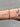 Bracelet on a wrist with tattoos against a neutral background