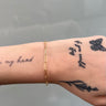 long paperclip link gold chain on wrist