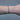 Black chain with silver beads on a person's wrist on grey background
