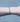 Black chain with silver beads on a person's wrist on grey background