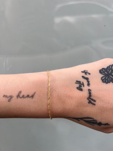 Infinity link gold chain on a wrist