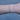 Gold chain on a person's wrist on a white backgriound