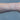 Gold chain on a person's wrist on a white background