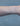 Gold chain on a person's wrist on a white background