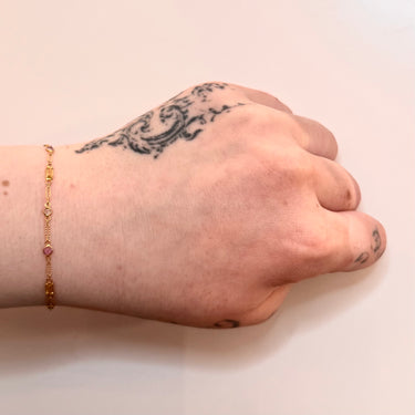 Gold bracelet with colorful sapphire on model