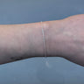 silver chain with pretzel shaped links on a wrist