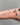 Silver figaro style chain on wrist
