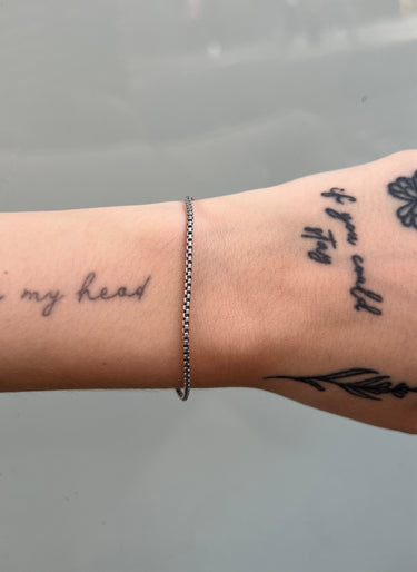 oxidized silver box chain on a wrist