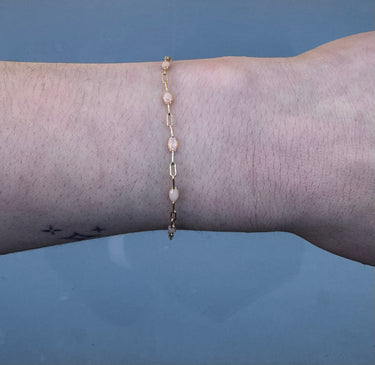 paperclip chain with pink enamel beads on a wrist