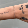 Silver paperclip style chain on wrist