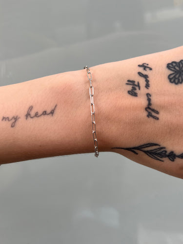 Silver paperclip style chain on wrist