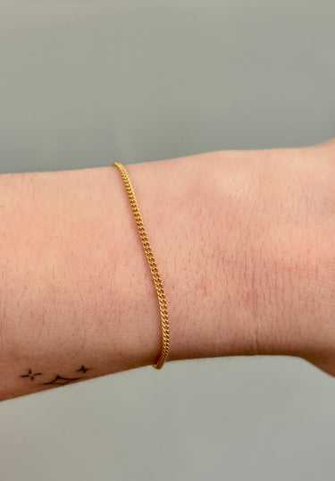 gold filled thin curb chain on wrist