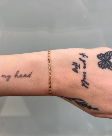 starburst link flat gold filled chain on wrist