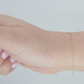 Gold chain on a person's wrist