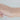 Gold chain on a person's wrist