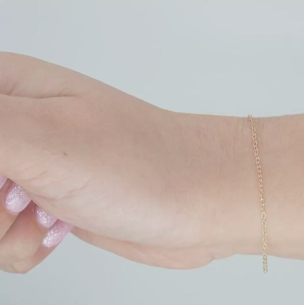 Gold chain on a person's wrist