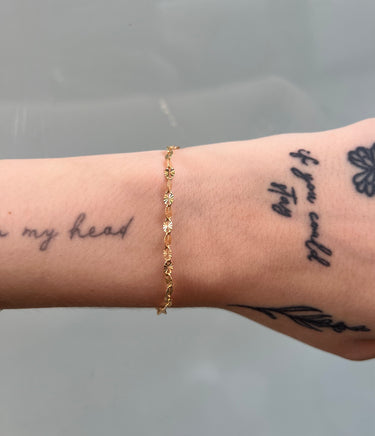 14k gold filled starburst link chain on wrist
